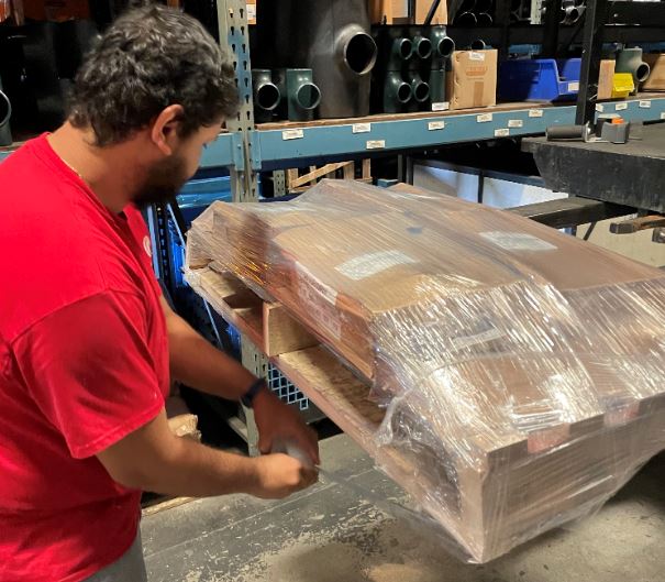 Image of associate wrapping a pallet